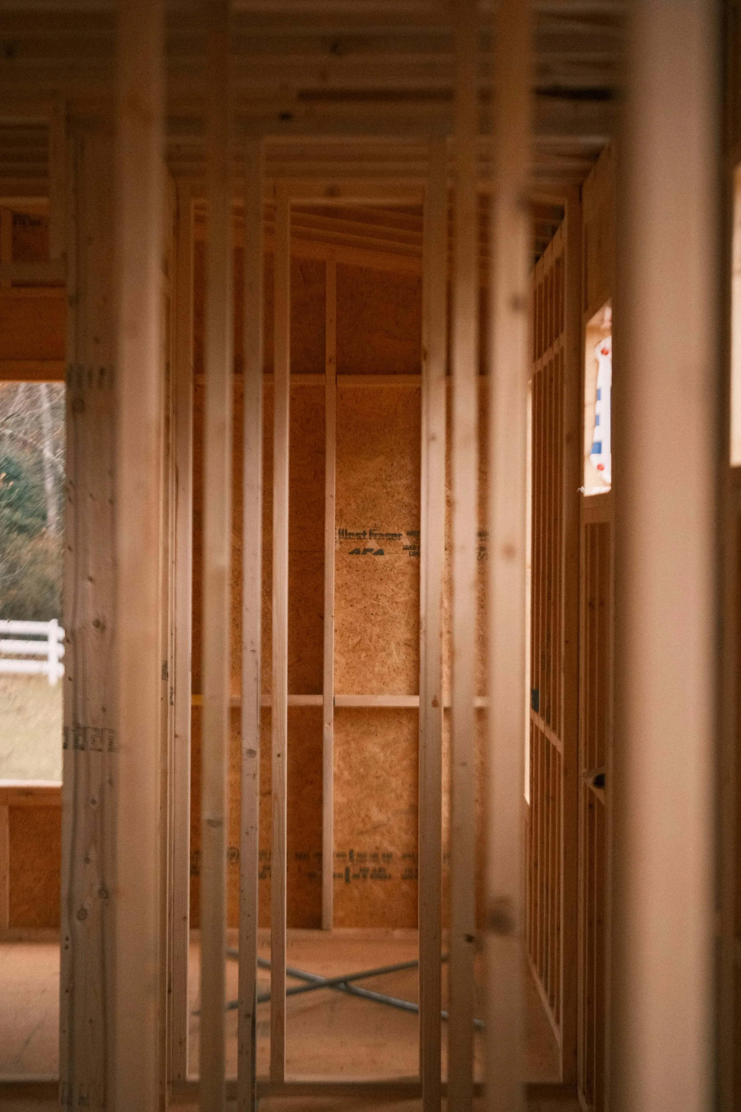 Stud-framed doorway inside a garage being converted to a living space